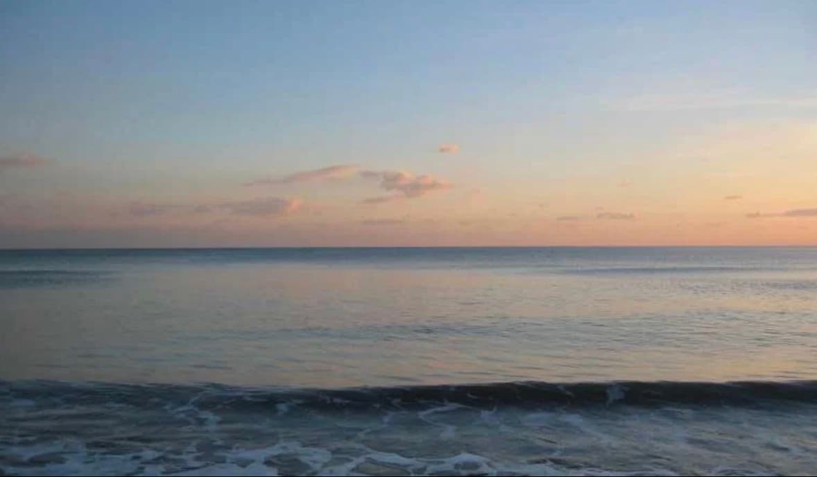 Sunset over the nearby British coastline
