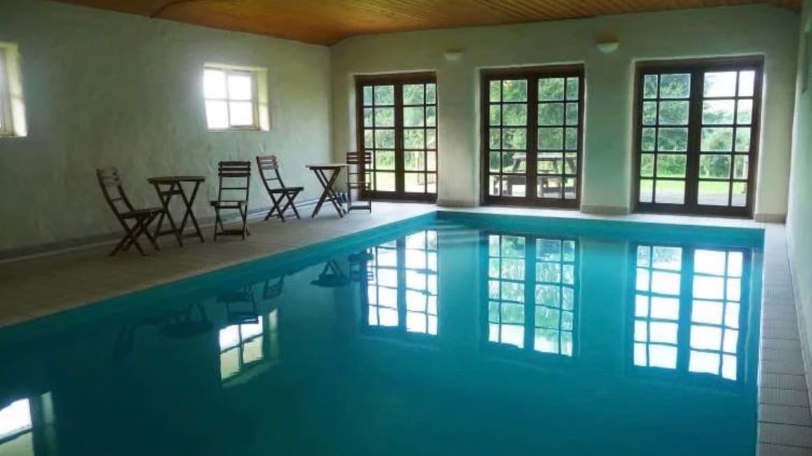 The indoor heated pool and lounge seating