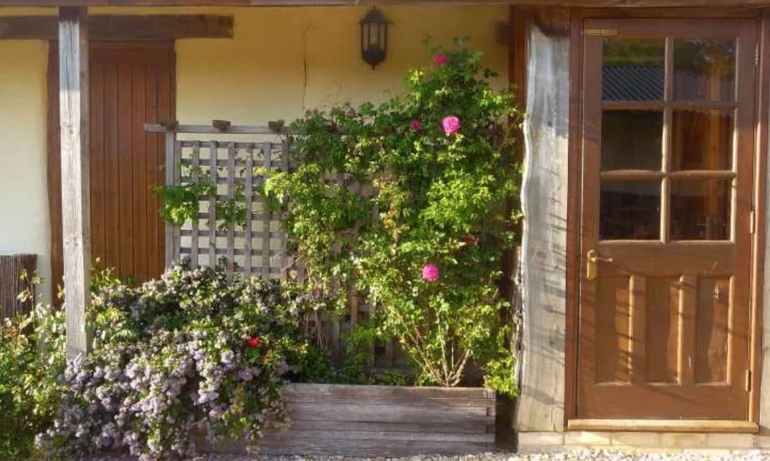 A rose-framed entrance to the accommodation